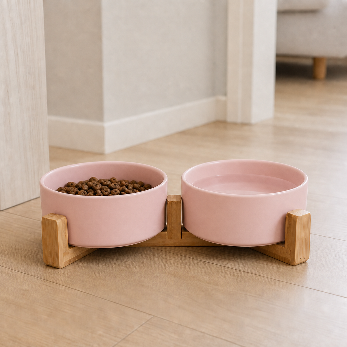 Pink Dine ceramic cat bowls on a bamboo stand with kibble and water